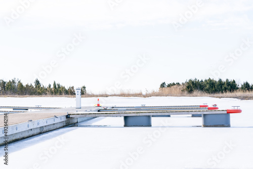 Early spring ice remains and the boat slips are embpty  in early March at the harbour in Orjaku. photo