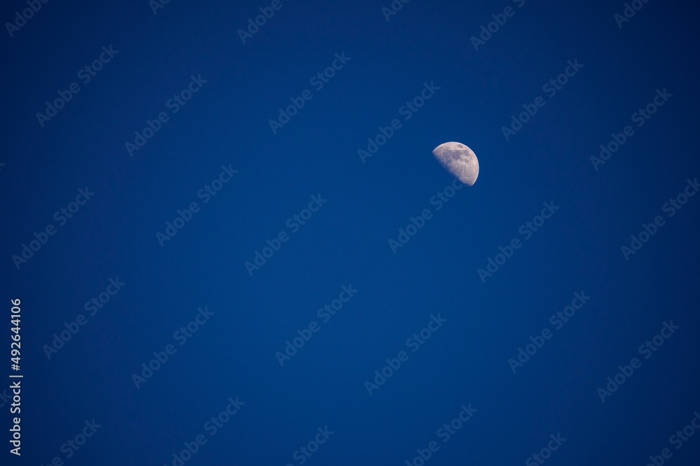 The moon rising in a darkening sky. The moon rising in a darkening sky.