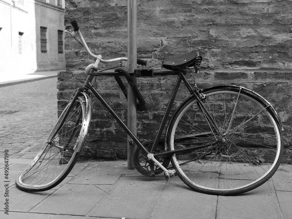 Heavily damaged bicycle tied to a pole. Heavily damaged bicycle tied to a pole.