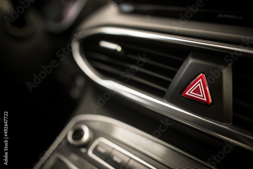 Triangle button on black car dashboard © bizoo_n