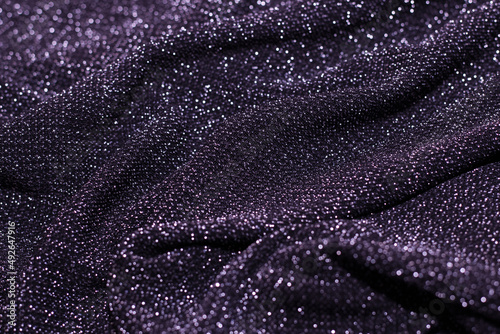 Texture of shiny sparkling lurex fabric purple lavender color.