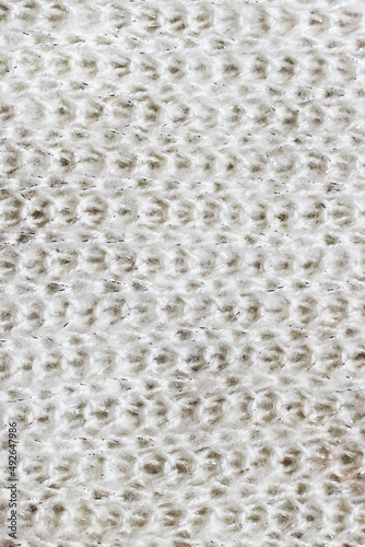 Texture of natural warm knitted fabric pattern white color.