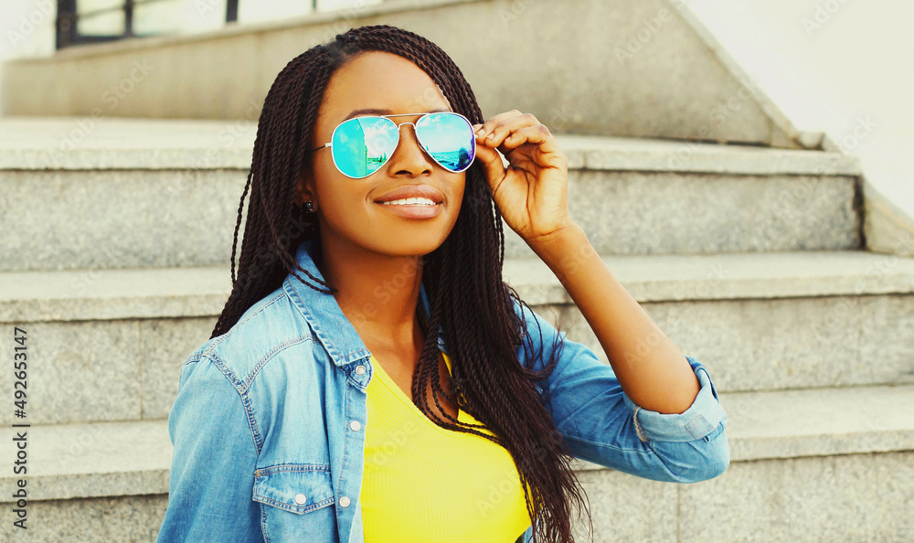 Portrait of happy smiling young african woman in casual in the city Portrait of happy smiling young african woman in casual in the city