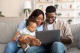 Portrait of black family using tablet at home