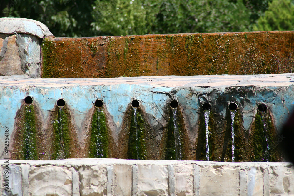 Fototapeta premium Pour water from the waterway in the garden