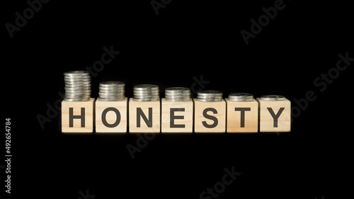 Photos honesty - word of wooden blocks with letters on a black background