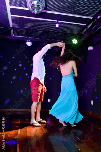 couple dancing waltz in nightclub 