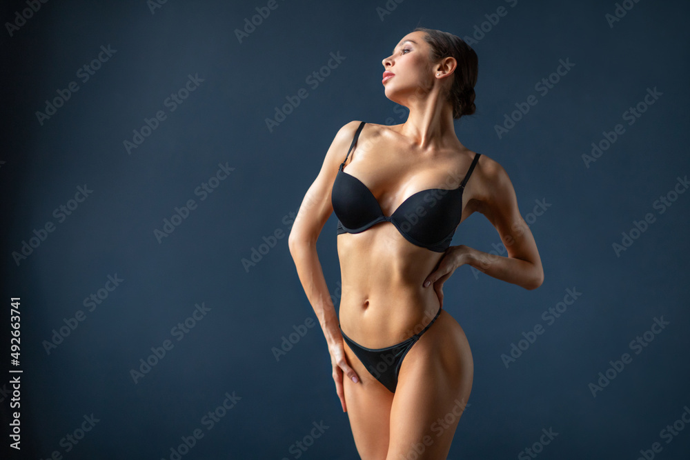 Beautiful sensual fitness woman with a good figure in black underwear, posing. Beautiful sensual fitness woman with a good figure in black underwear, posing.