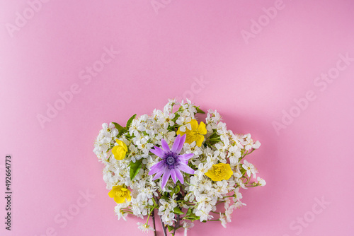 Spring flower bouquet on a lilac background with a space for text