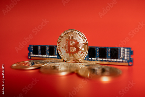gold coins bitcoin and RAM on a red background