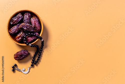 Ramadan concept. Black islamic rosary with crescent with dates fruits photo