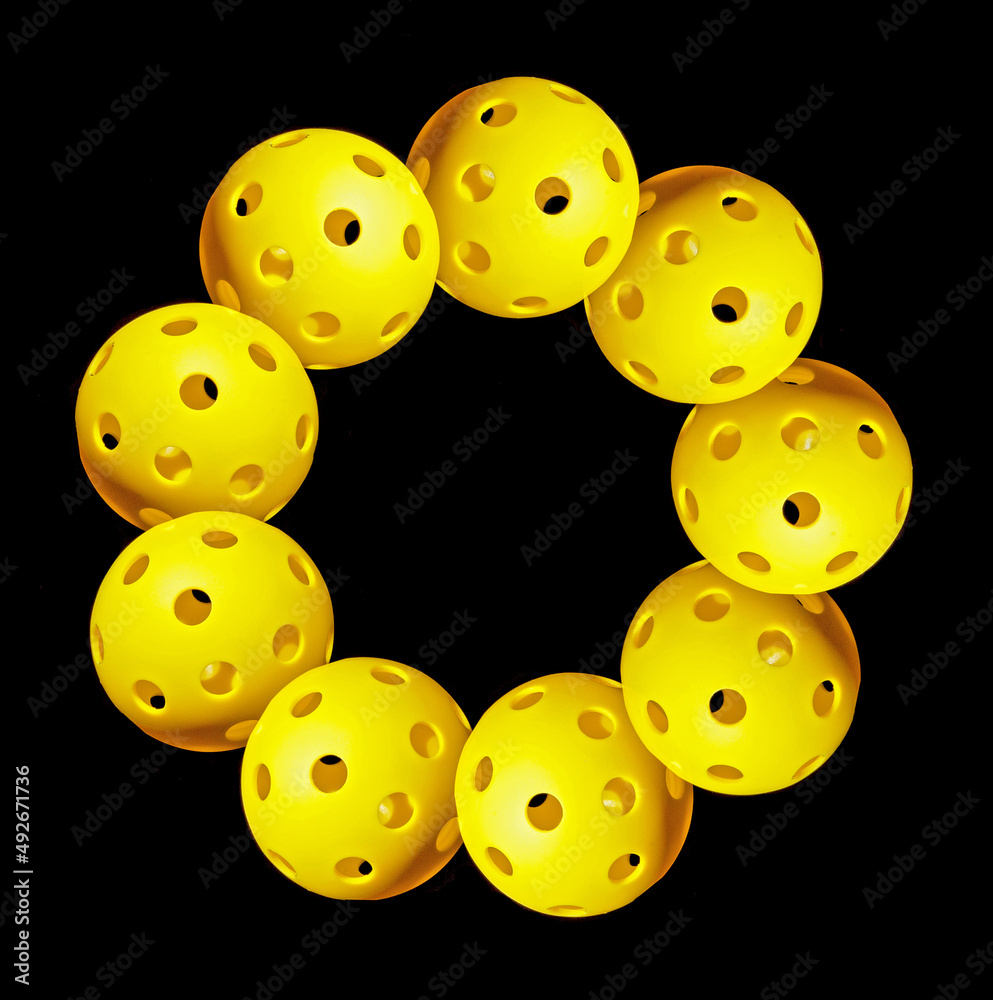 Pickleball 9 Circle. Nine yellow overlapping Pickleballs in a circle with black background. Pickleball 9 Circle. Nine yellow overlapping Pickleballs in a circle with black background.