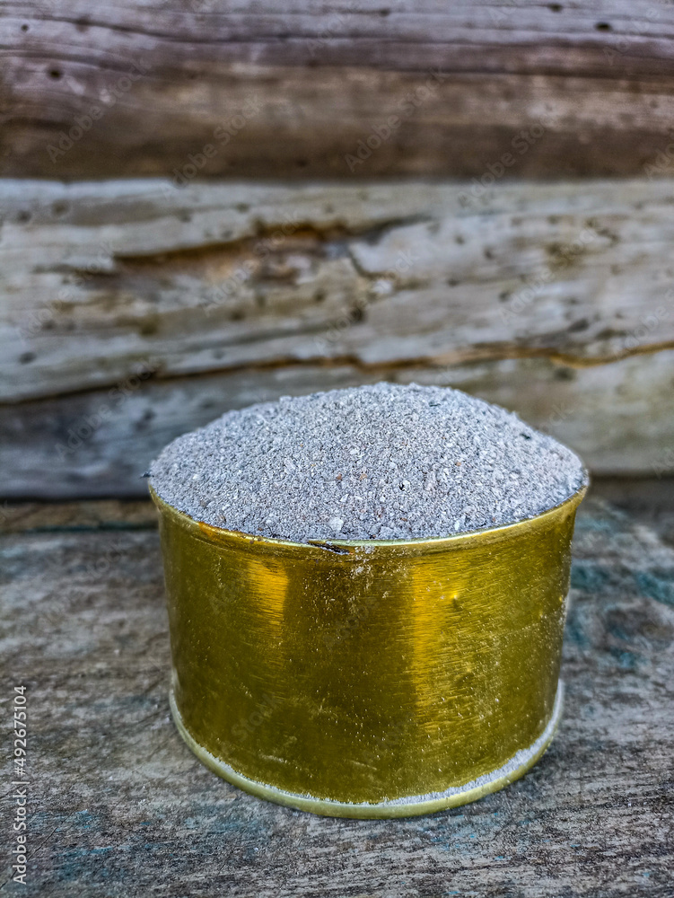 Bucket full of ashes as natural fertilizer. Outdoor shot. Bucket full of ashes as natural fertilizer. Outdoor shot.