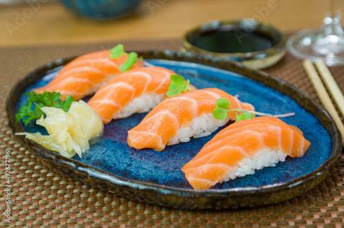 Delicious premium salmon nigiri on blue plate