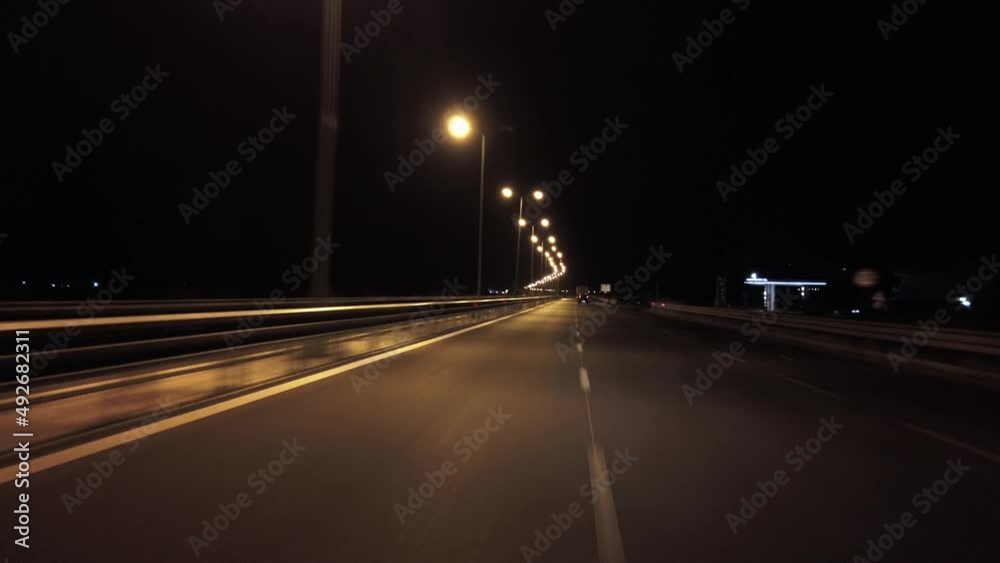 POV in the car, driving on a dark empty road, highway  in the middle of the night