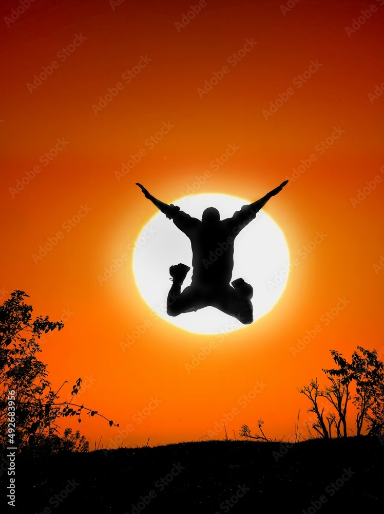 silhouette of a person jumping on sunset 