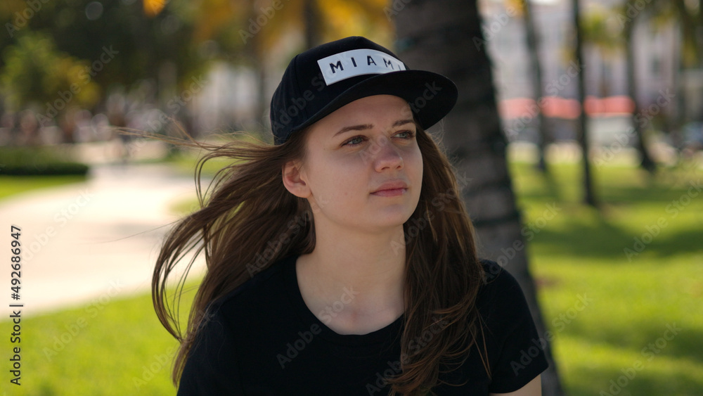 Young woman relaxes in the sun at the promenade of Miami South Beach Young woman relaxes in the sun at the promenade of Miami South Beach
