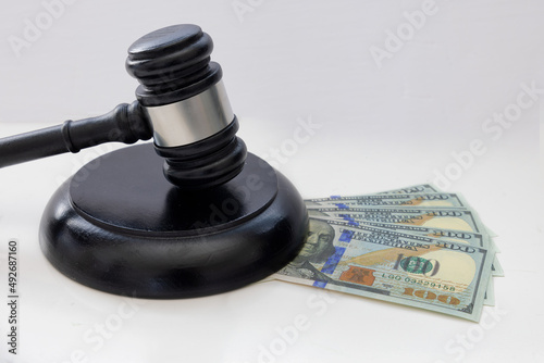 Wood Gavel and Sound Block and American Banknotes.Concept: Justice cost