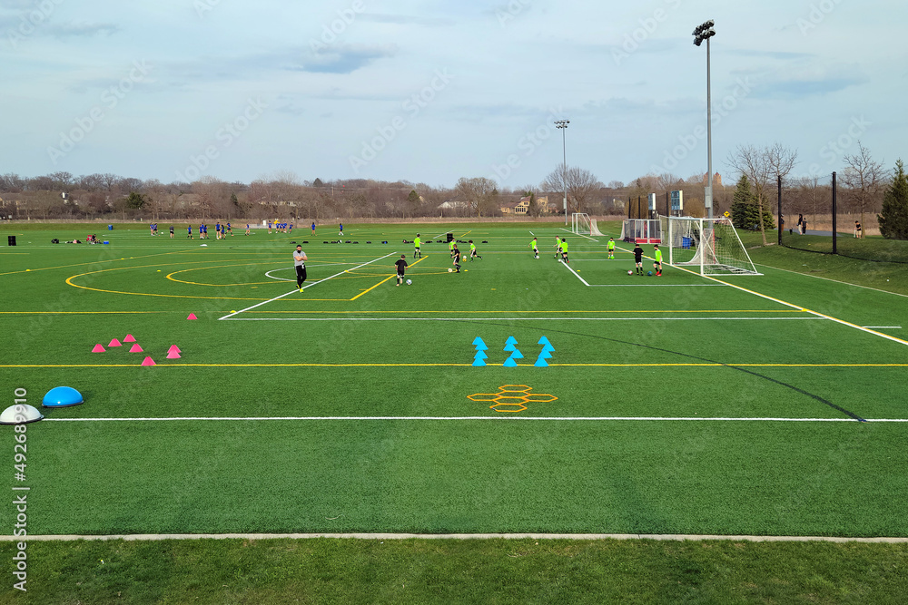 Fototapeta premium Boys practicing soccer on a multi-use ball field