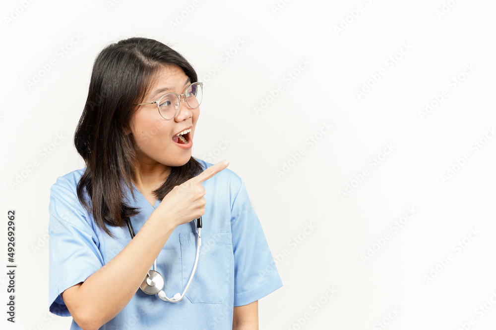 Showing Product and Pointing Side Of Asian Young Doctor Isolated On White Background Showing Product and Pointing Side Of Asian Young Doctor Isolated On White Background