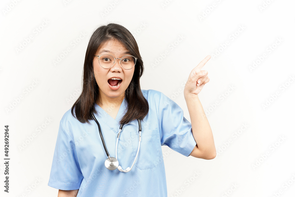 Showing Product and Pointing Side Of Asian Young Doctor Isolated On White Background Showing Product and Pointing Side Of Asian Young Doctor Isolated On White Background