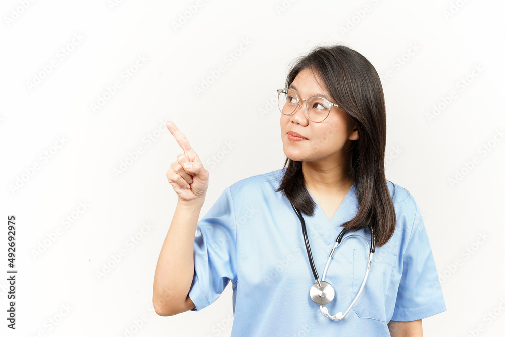 Showing Product and Pointing Side Of Asian Young Doctor Isolated On White Background Showing Product and Pointing Side Of Asian Young Doctor Isolated On White Background