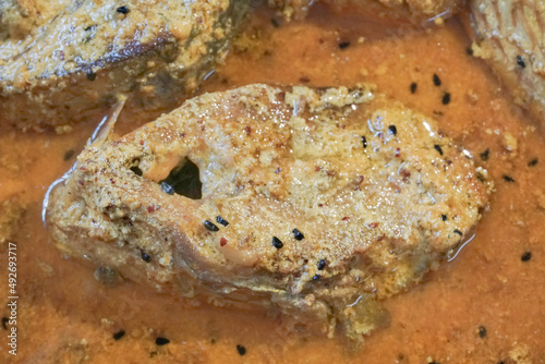 Tenualosa ilisha (ilish, hilsa, hilsa herring or hilsa shad) fish pieces on plate, spicy Indian dish. It is Bangladesh's national fish. Hugely popular amongst Bengalis and south Asia for it's taste. photo