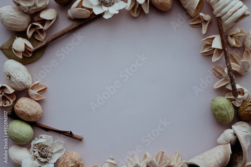 Flat lay with room for copy space with flowers, nuts, and other woodland decorations.