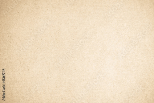 Brown recycled craft paper texture background. Cream old vintage page cardboard or grunge vignette.
