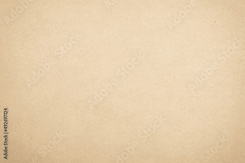 Brown recycled craft paper texture background. Cream old vintage page cardboard or grunge vignette.