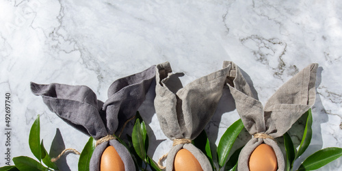 Wall Mural Festive easter background with Easter bunny eggs on linen napkin
