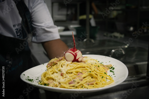 Chef holding a spaghetti carbonara
