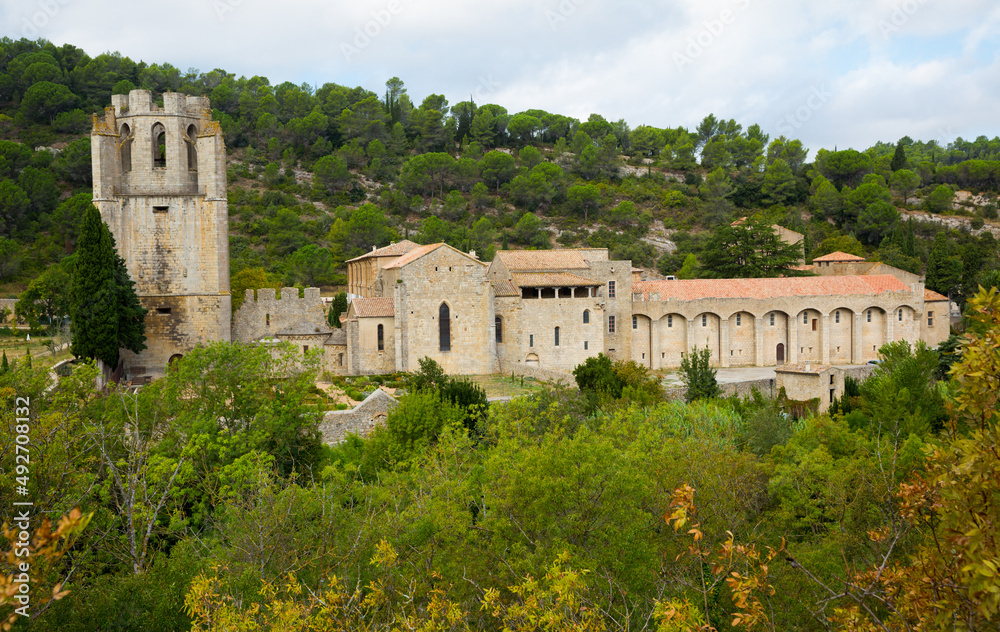 View of medieval bell tower of Benedictine monastic complex of Saint Mary in French commune of Lagrasse ..