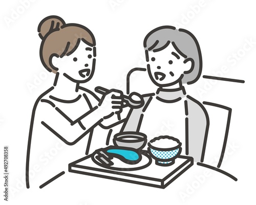 若い女性がシニアの食事介助をするベクターイラスト素材／車椅子／高齢者／福祉士