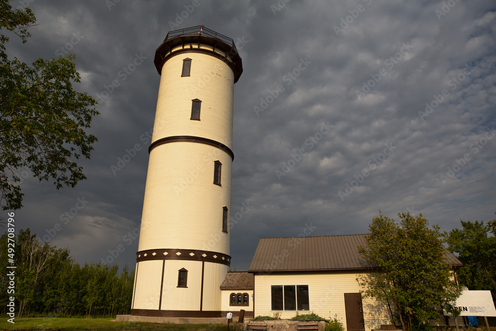A painted and preserved old water tower with staggered windows serving as a tourist attraction