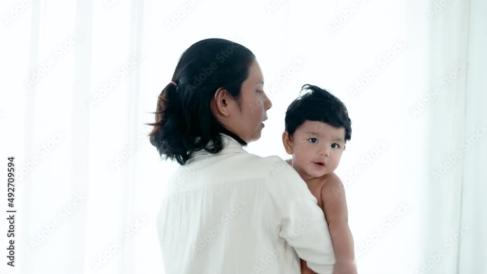 4K 50fps, An Asian mother holds her adorable newborn son in her arms, pulling him to a warm and comfortable sleep. Family and Healthy. 4K 50fps, An Asian mother holds her adorable newborn son in her arms, pulling him to a warm and comfortable sleep. Family and Healthy.