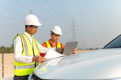 Architect at work in a construction site Engineers man construction safety work concept and construction city .Engineer Concept