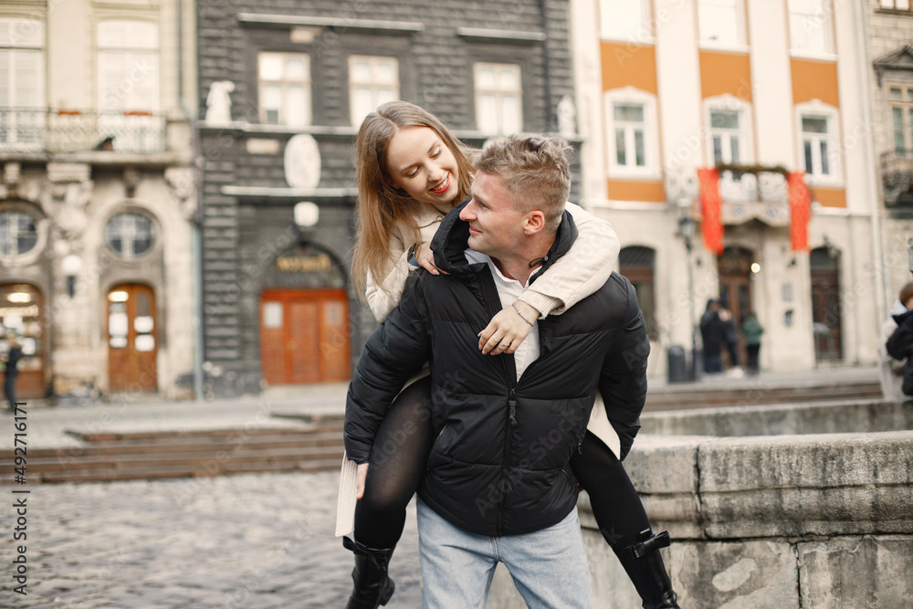 Fototapeta premium Romantic couple hugging while walking in the street of old town