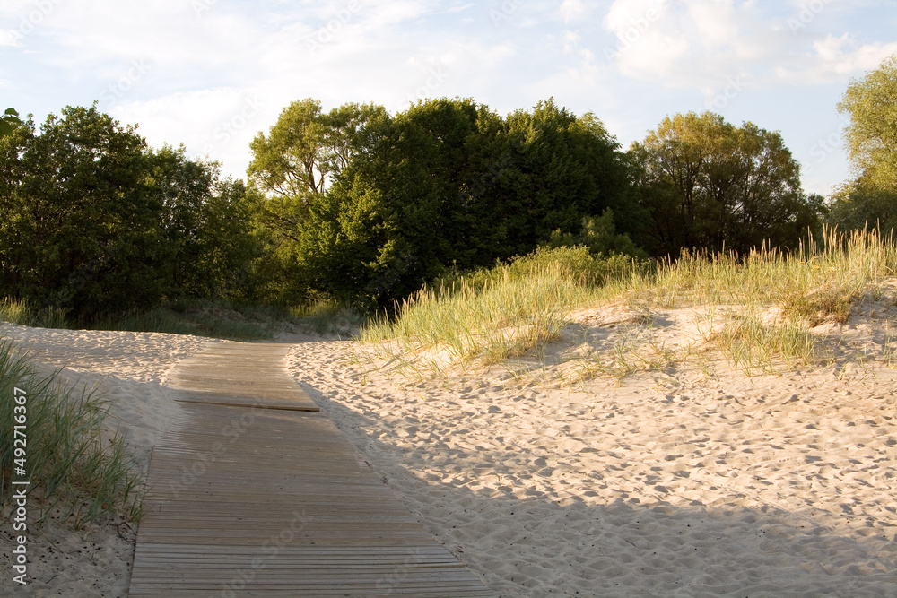 Wooden pathway at a beach in Pärnu, Estonia, on a sunny day at summer. Wooden pathway at a beach in Pärnu, Estonia, on a sunny day at summer.