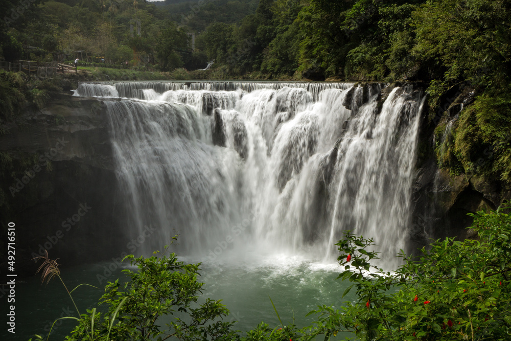 Fototapeta premium Scenic view of the Shifen Waterfall along the Keelung River in Pingxi District, New Taipei City, Taiwan.