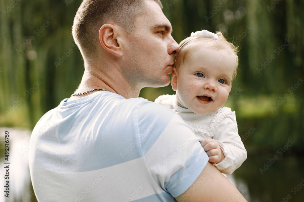 Portrait of a little baby girl sitting on her father's hands Portrait of a little baby girl sitting on her father's hands