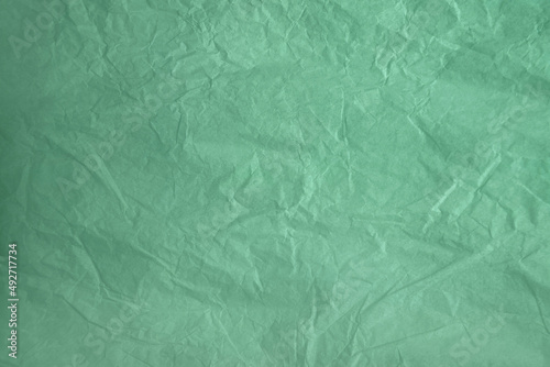 Empty eco friendly pastel green Neo mint or Aqua menthe color on recycled organic crumpled paper for the environment creative style background
