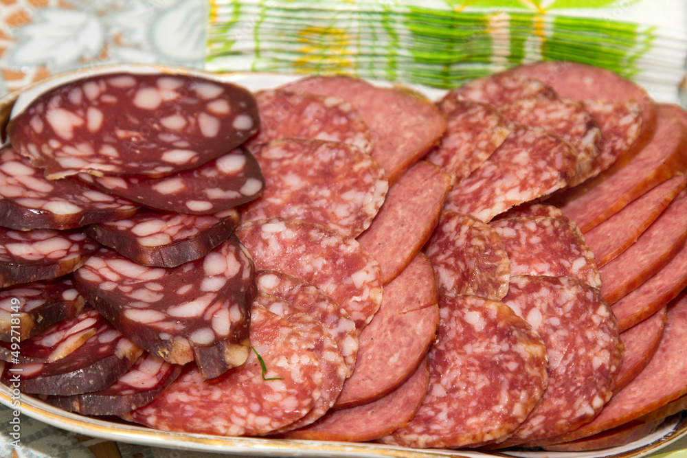 Cut sausage of sausage of different varieties on a plate Cut sausage of sausage of different varieties on a plate