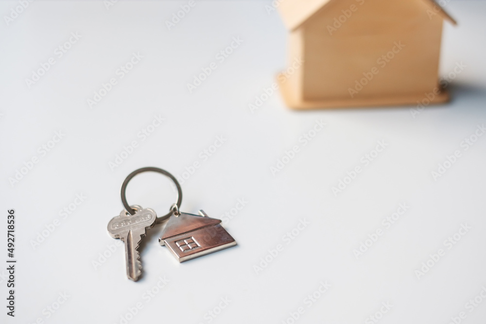 key with wooden Home model. Real estate, buy and sale, Property insurance, rental and contract agreement concepts key with wooden Home model. Real estate, buy and sale, Property insurance, rental and contract agreement concepts