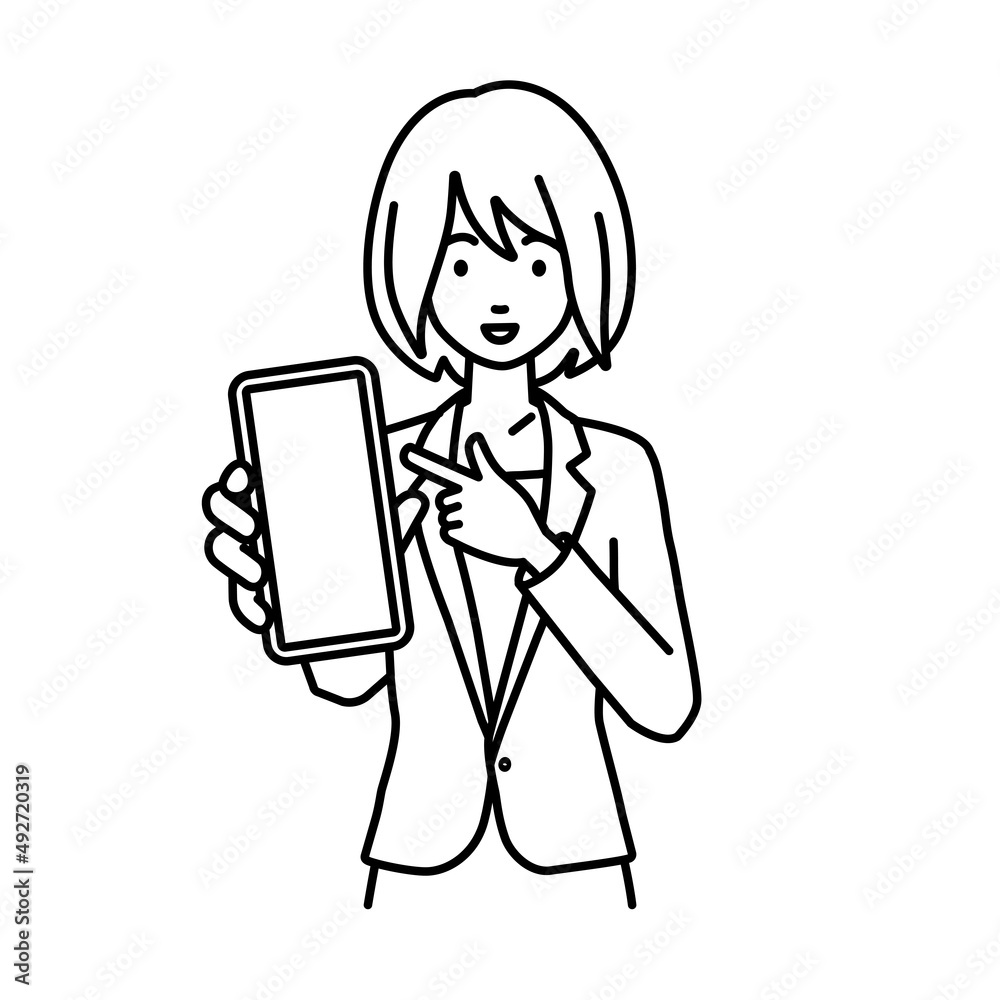 立ってスマートフォンを指差してこちらに向けて見せているスーツの女性