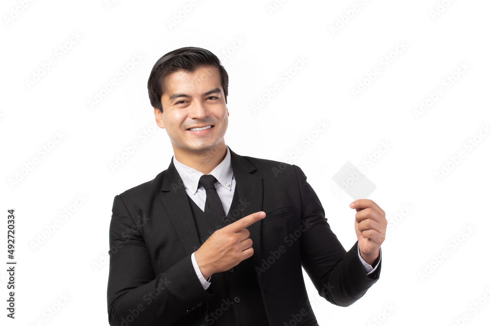 Handsome business man in black suit holding and finger pointing to credit card isolated on white background. Business, technology, ecommerce and online payment concept. Handsome business man in black suit holding and finger pointing to credit card isolated on white background. Business, technology, ecommerce and online payment concept.