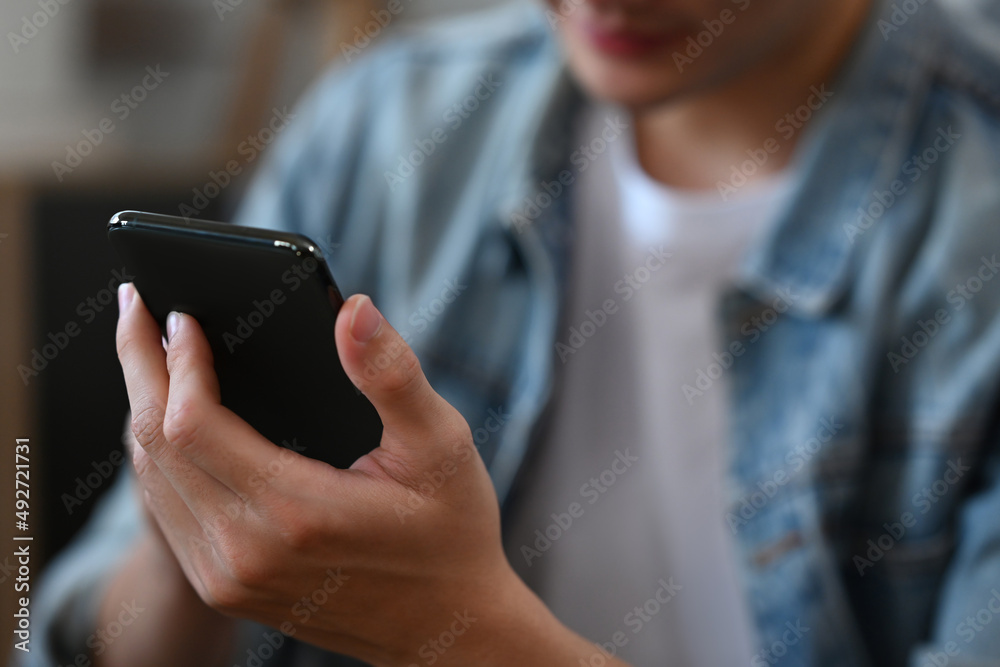 Close up image of male typing text message on smartphone. Close up image of male typing text message on smartphone.