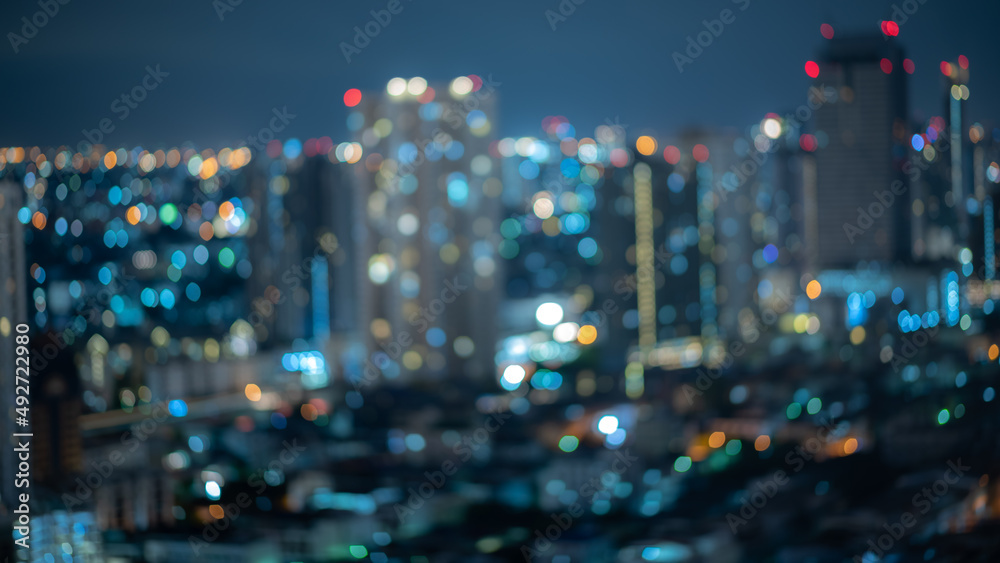 abstract blurry background of city night light, cityscape background in defocus with colorful light of city urban, modern lifestyle using for travel and business concept
