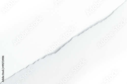 White torn paper diagonally on white background