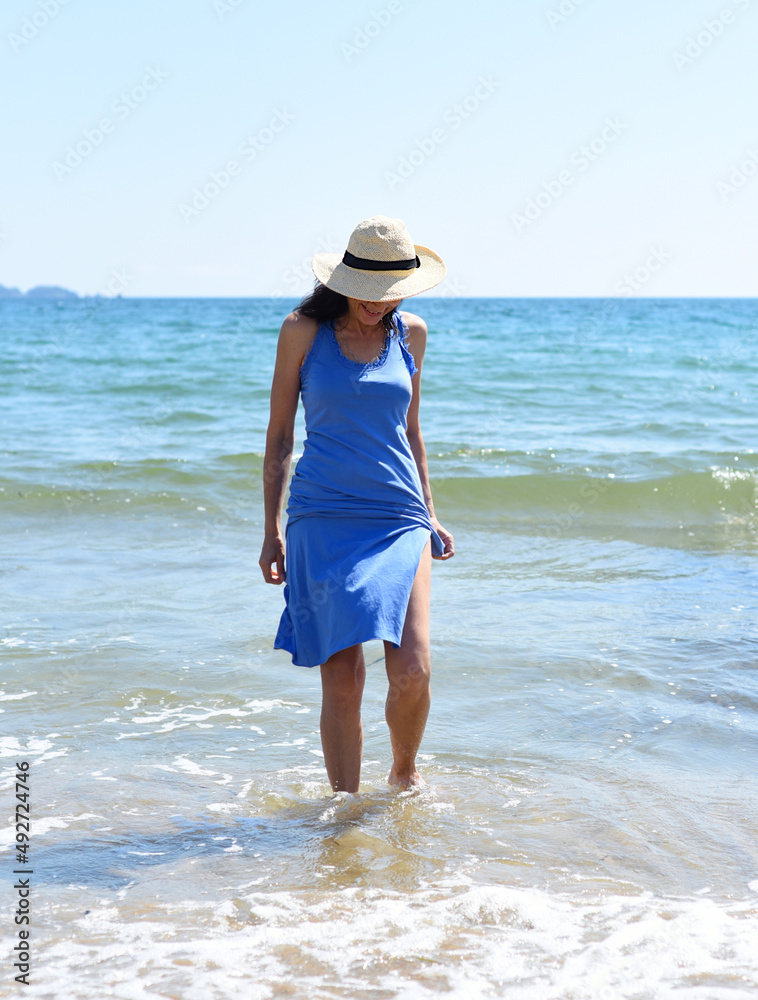 45 years old Russian woman  standing in Japanese sea and looking away